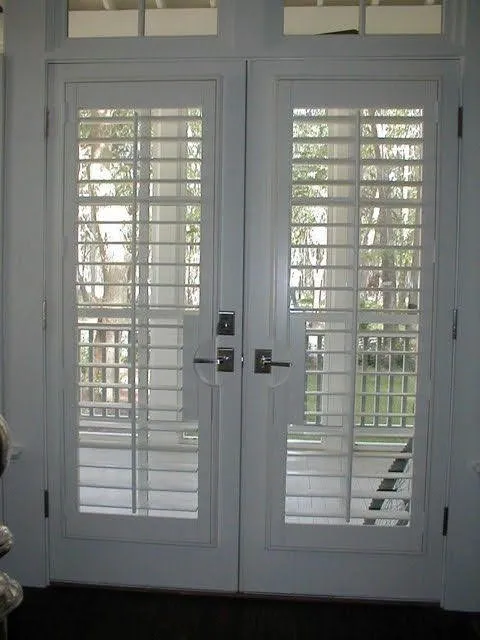 White plantation shutters on a pair of French doors
