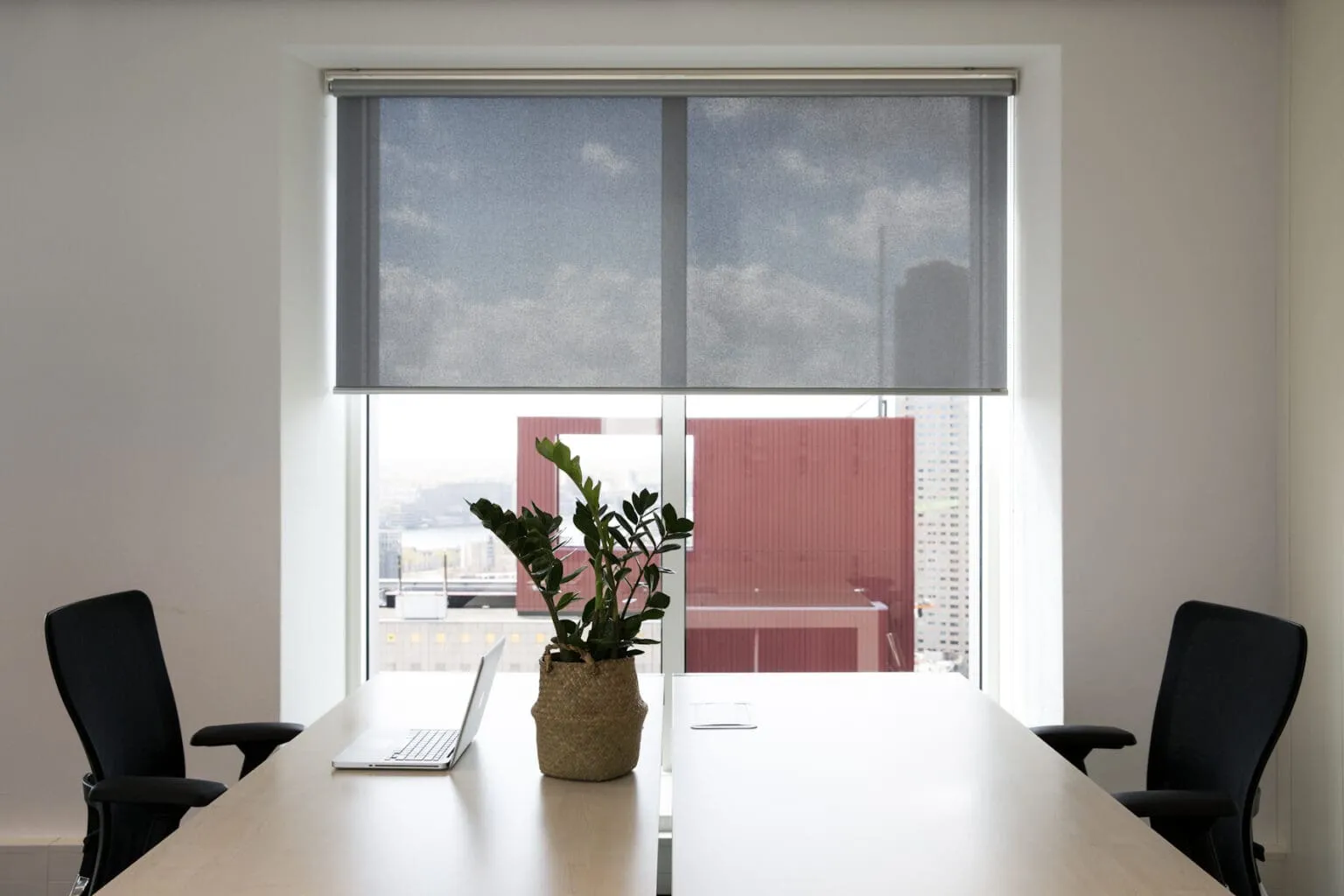 Gray shade over a high-rise office window