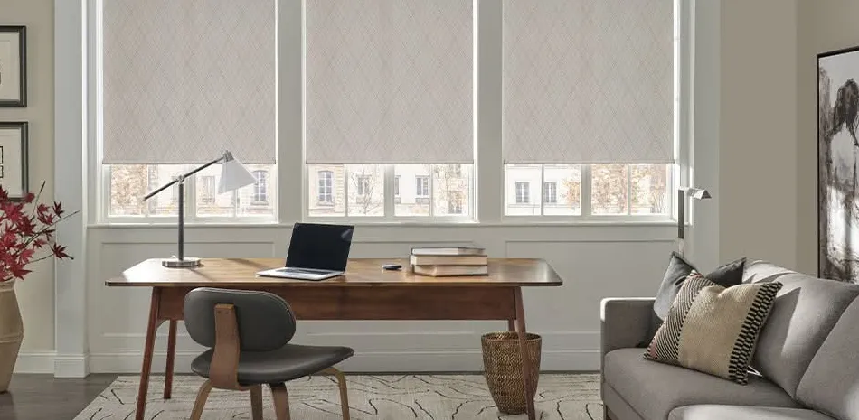 Flat Roman shades in a diamond-weave fabric over a home office