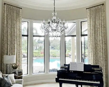 White honeycomb shades covering a sliding glass door